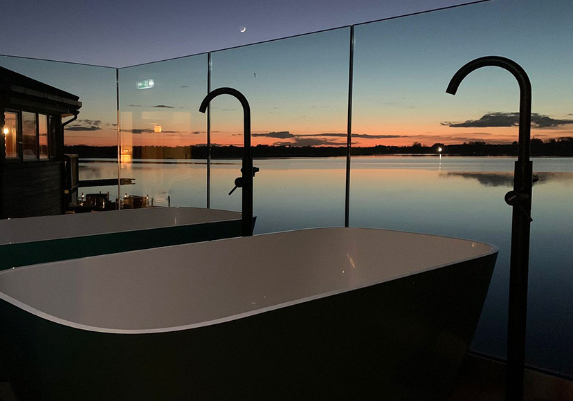 Outdoors bathtubs at dusk at Cedarwood Spa.